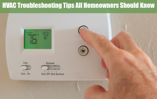 Person adjusting the temperature on their thermostat as an HVAC troubleshooting trick.